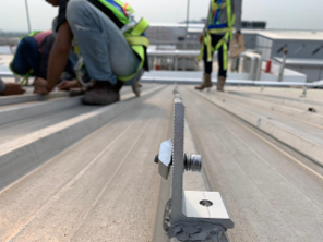 Solar panel mounting rail bonded to a metal roof with LORD 810 structural adhesive
